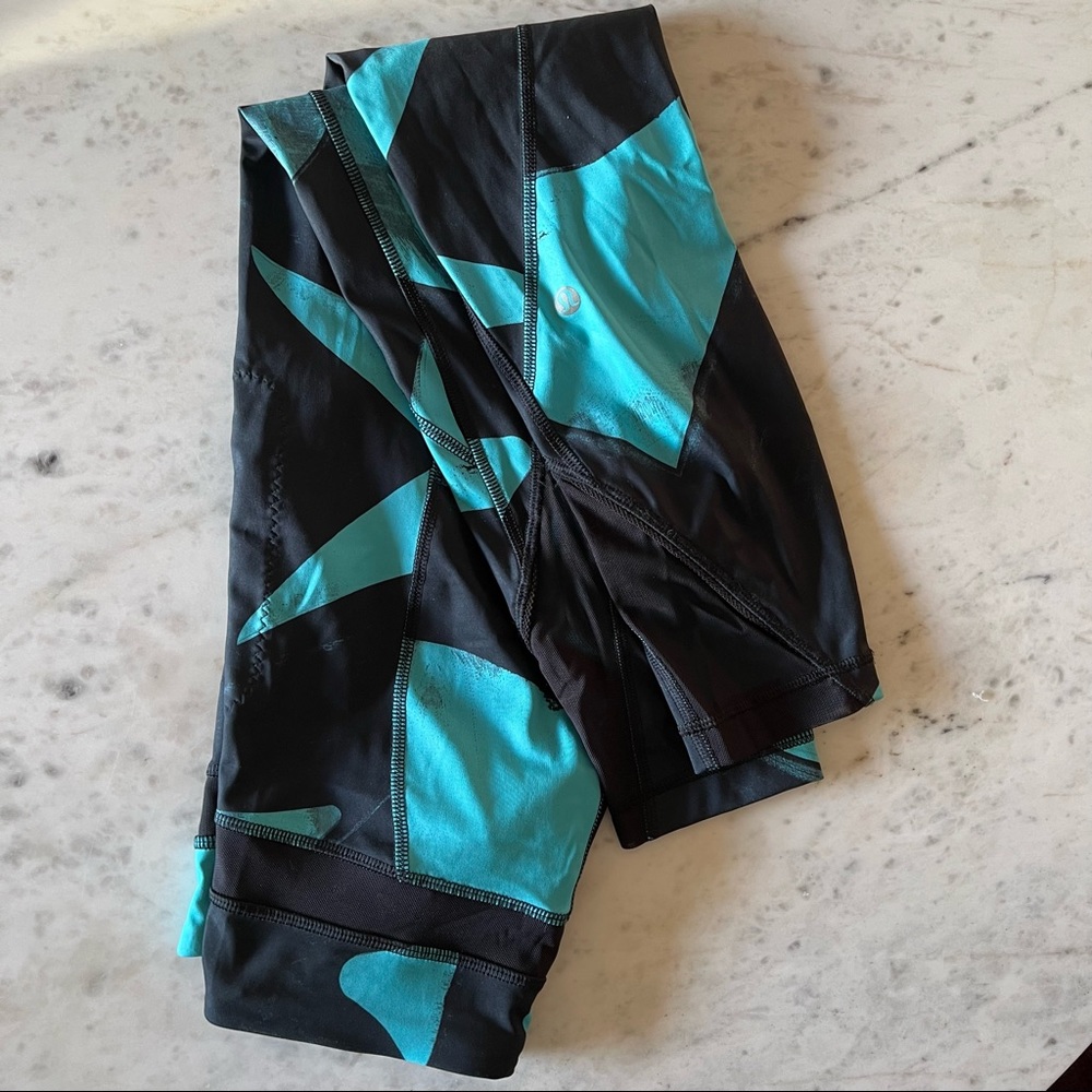 Lulu Lemon mid-rise leggings with mesh details and zipper pockets